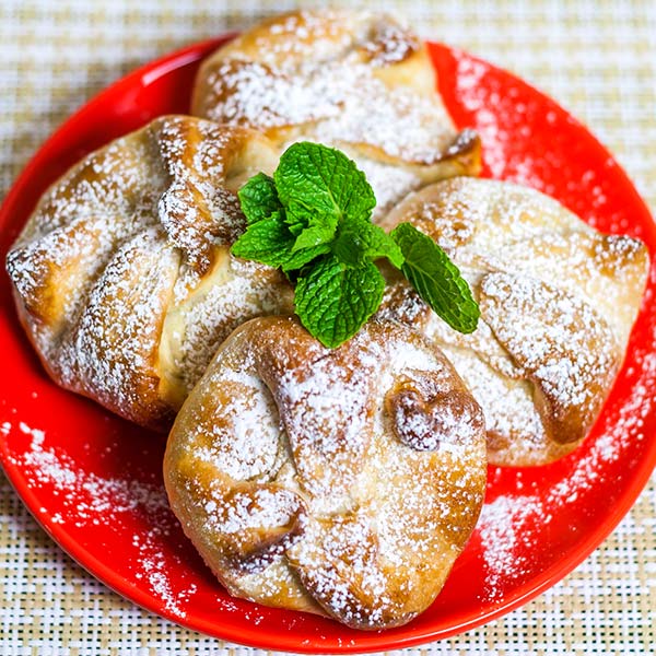 Delicious Romanian pastries filled with a mix of Ricotta cheese or any other sweet cheese you might like and golden raisins.