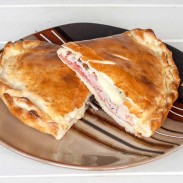 Home-made calzone loaded with various Italian cold cuts