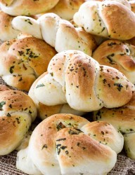 Delicious bread knots with basil and butter
