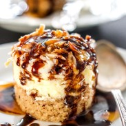 Decadent mini cheesecakes with pineapple on a pecan crust and topped with sweetened coconut flakes.
