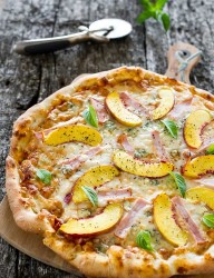 A delicious combination of peaches and Canadian back bacon on a pizza flatbread