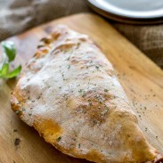 A delicious rustic looking calzone made with loads of ham and cheese, the perfect breakfast.