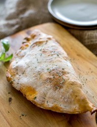 A delicious rustic looking calzone made with loads of ham and cheese, the perfect breakfast.