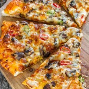 Delicious and light summer pizza with chicken and two types of mushrooms