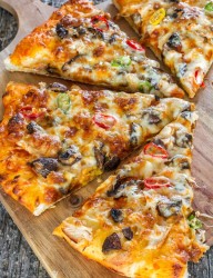 Delicious and light summer pizza with chicken and two types of mushrooms