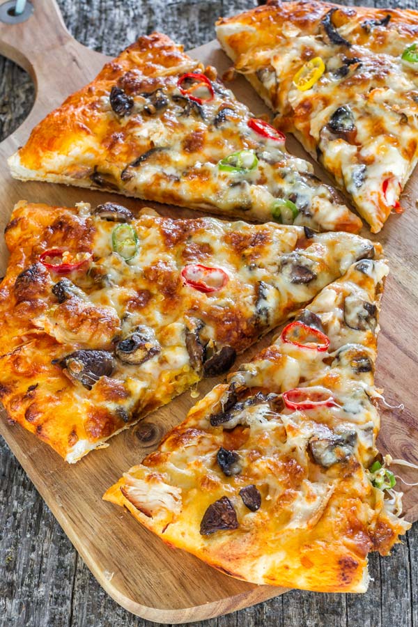 Delicious and light summer pizza with grilled chicken and two types of mushrooms