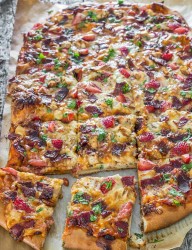 Delicious chicken and bacon pizza featuring strawberries sprinkled with balsamic reduction